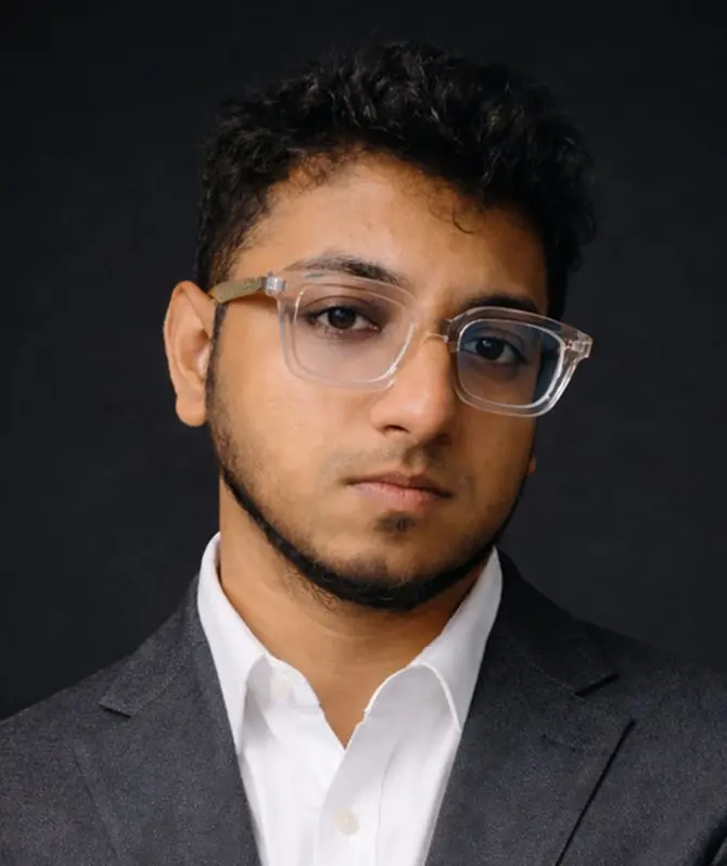 Nasif Fuad in a charcoal suit and clear glasses